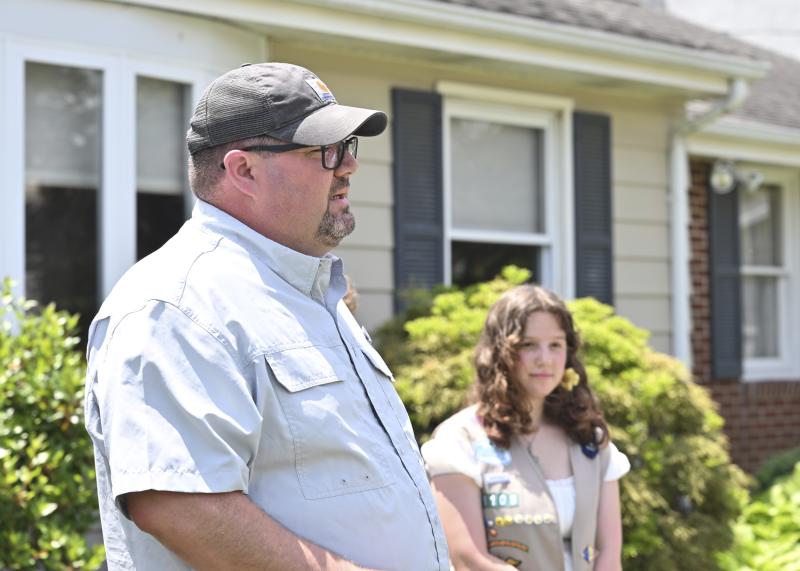 Ray Davis, director of youth and family ministries at Bethel United Methodist Church, gives a short speech as Adrianna Kollar stands in the back.