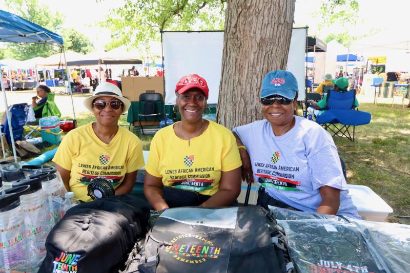 Volunteers working the welcome table with Juneteenth T-shirts, hats and water bottles are (l-r) Rhoda Brown, Monique Jones and Sharon Hines.