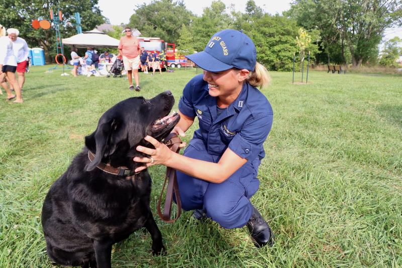 Lt. Danielle Taylor, commander of the newly established Coast Guard Marine Safety Unit Lewes, hugs her dog, which is named Dog.